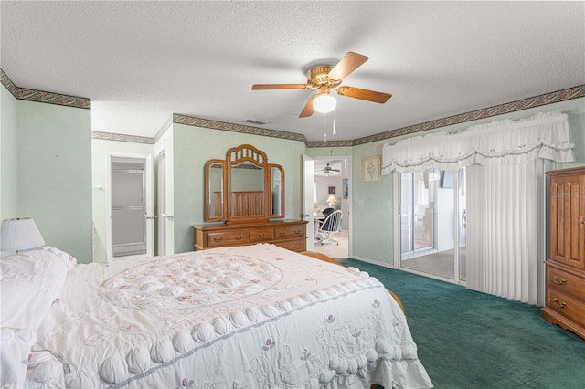 carpeted bedroom with a textured ceiling and ceiling fan