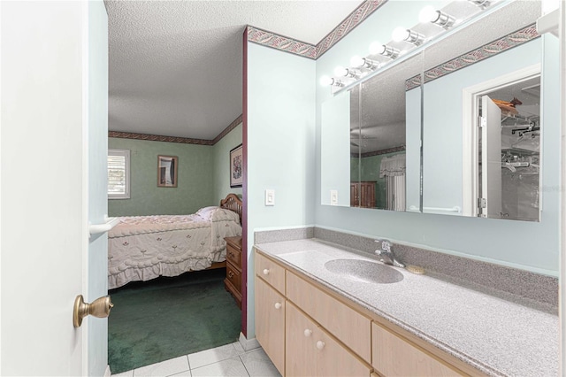 bathroom featuring a textured ceiling, vanity, tile patterned floors, and crown molding