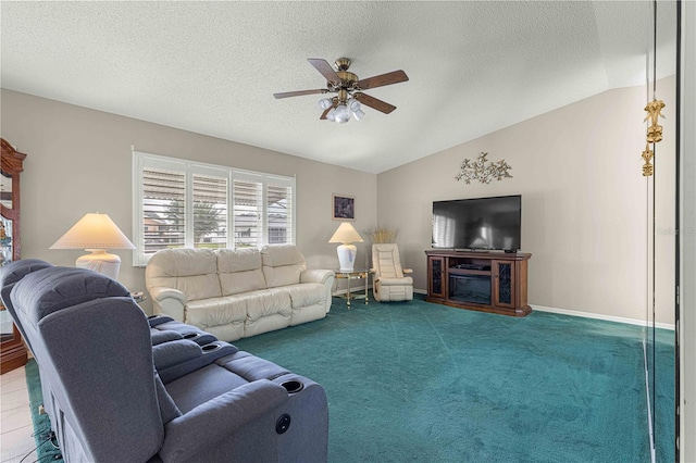 living room with lofted ceiling, ceiling fan, carpet flooring, and a textured ceiling