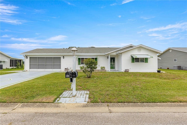 ranch-style home featuring a garage, a front yard, and central air condition unit