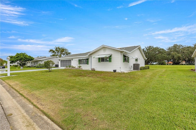 single story home featuring a front yard and cooling unit