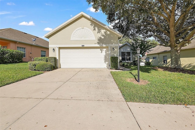 view of front of property with a garage and a front lawn