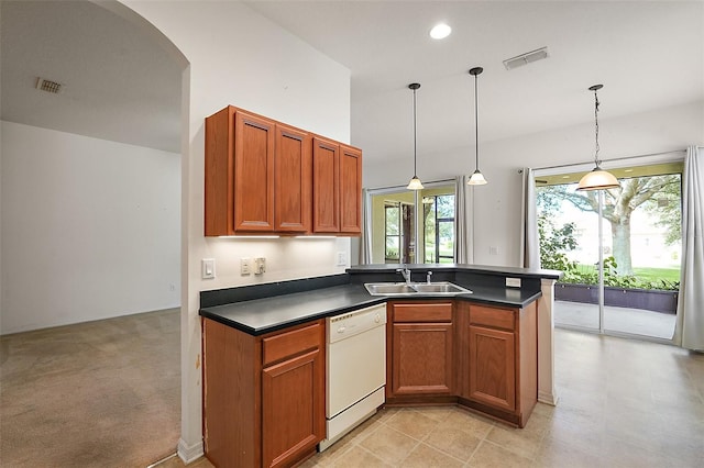 kitchen with light tile patterned floors, decorative light fixtures, white dishwasher, and sink