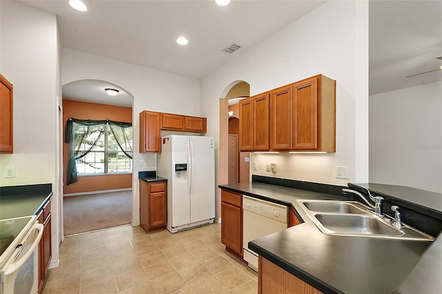 kitchen featuring light carpet, white appliances, sink, and ceiling fan