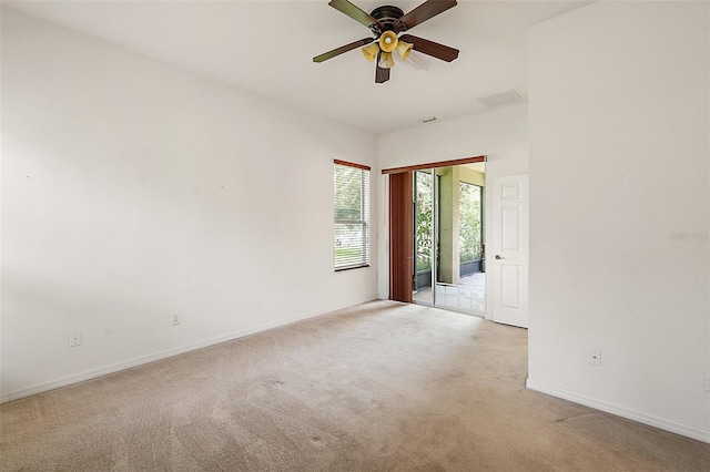 unfurnished room featuring light colored carpet and ceiling fan