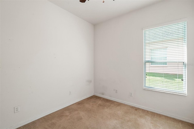 unfurnished room featuring light carpet