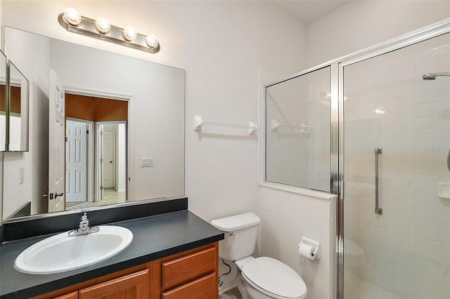 bathroom with vanity, toilet, and an enclosed shower