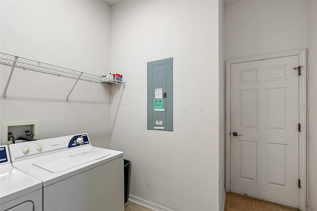 laundry room with washing machine and dryer, electric panel, and light tile patterned flooring