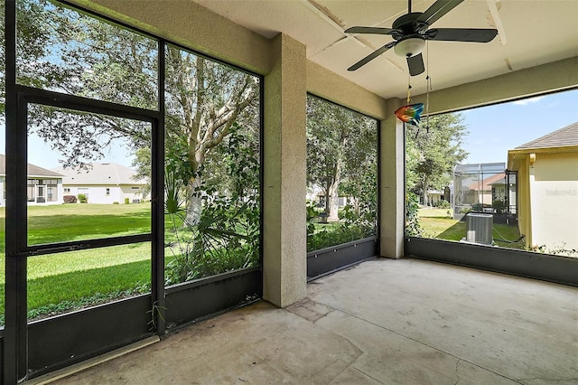 unfurnished sunroom with ceiling fan