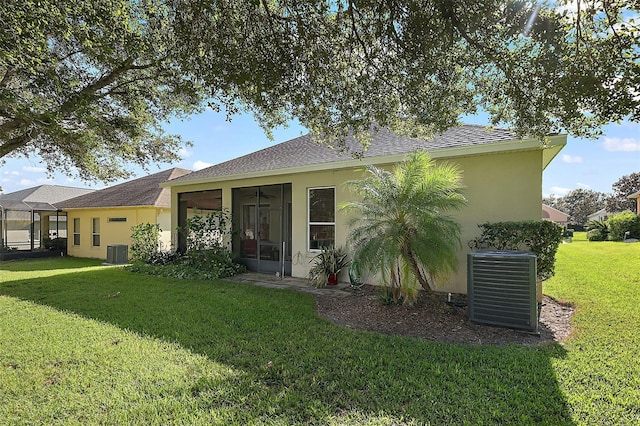 single story home featuring a front lawn and central AC unit