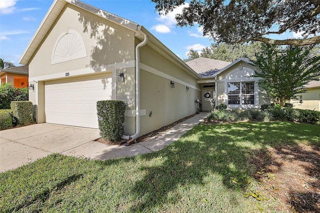 view of front facade with a garage and a front lawn