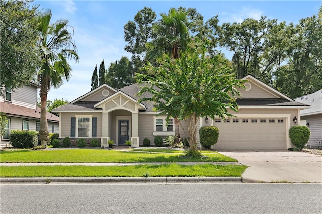 view of front of home with a garage and a front yard