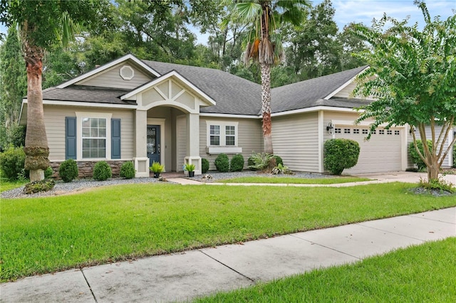 view of front of home with a garage and a front yard