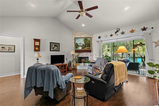 living room with ceiling fan, wood-type flooring, vaulted ceiling, and a fireplace