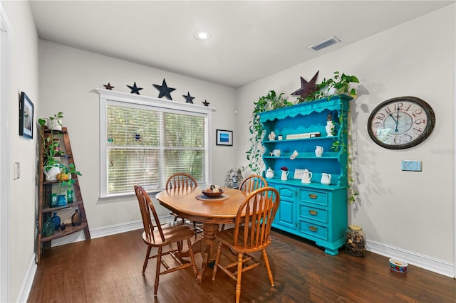 dining area featuring dark wood-type flooring