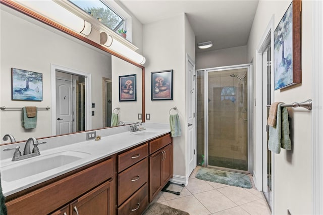 bathroom featuring vanity, a shower with shower door, and tile patterned floors