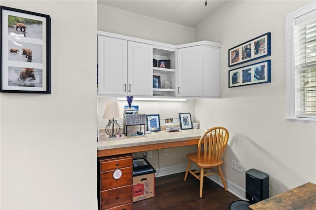 office area with built in desk and dark hardwood / wood-style floors