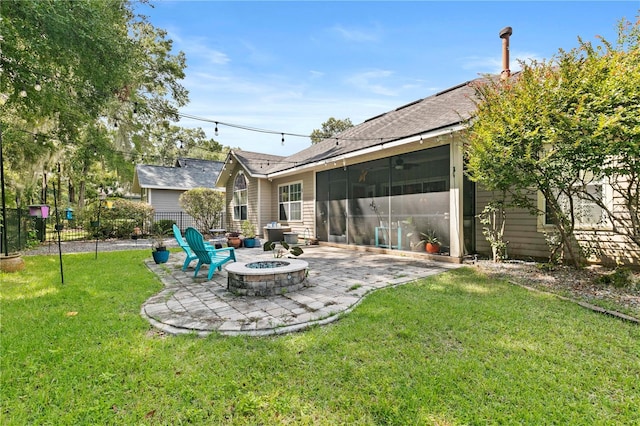 view of yard featuring a patio, a sunroom, and an outdoor fire pit