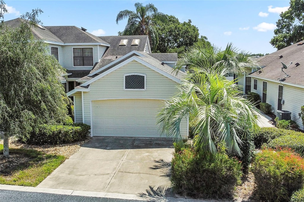 view of front of house with a garage and central AC