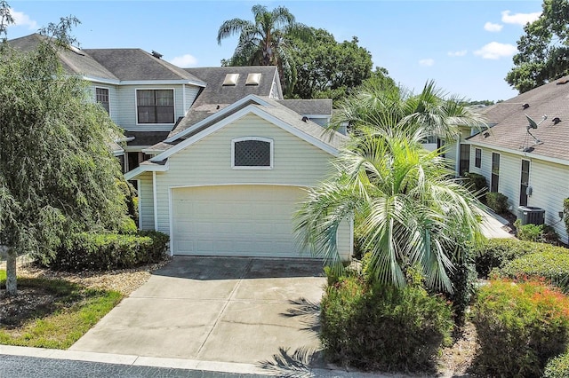 view of front of house with a garage and central AC