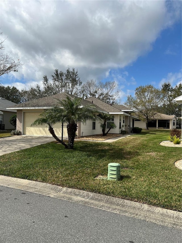 view of front of home with a garage and a front lawn