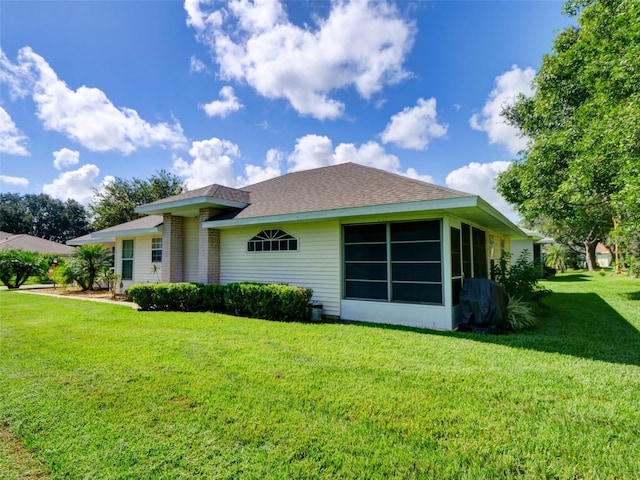 rear view of property featuring a lawn