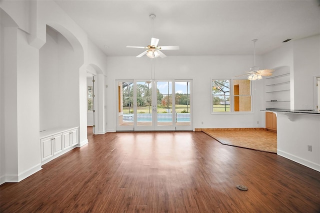 unfurnished living room featuring dark hardwood / wood-style floors, built in features, and ceiling fan