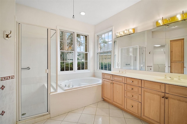 bathroom featuring tile patterned flooring, vanity, and shower with separate bathtub