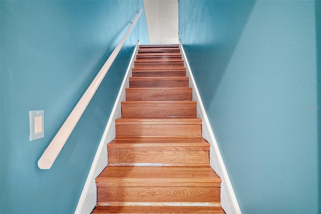 staircase featuring wood-type flooring