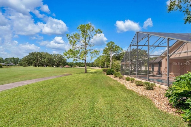 view of yard featuring a lanai and a swimming pool