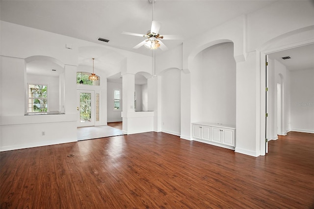 unfurnished living room featuring ceiling fan, dark wood-type flooring, and lofted ceiling