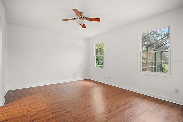 spare room with ceiling fan and dark hardwood / wood-style flooring