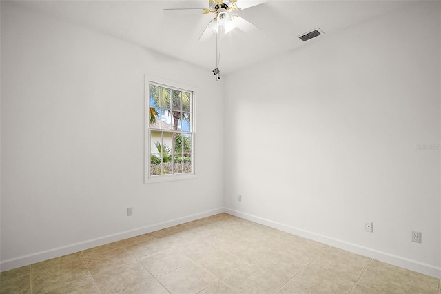 spare room featuring ceiling fan and light tile patterned flooring