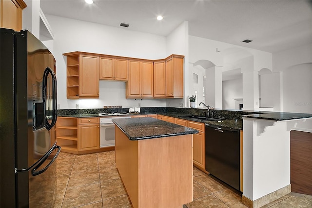 kitchen featuring a center island, black appliances, sink, dark stone countertops, and kitchen peninsula