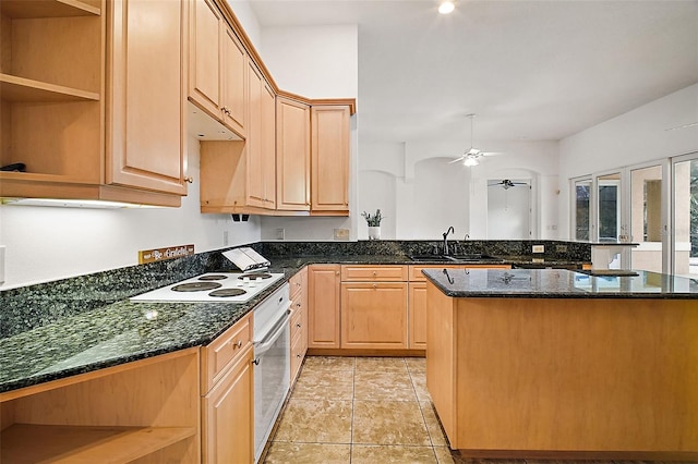 kitchen featuring dark stone countertops, ceiling fan, light brown cabinets, and white appliances