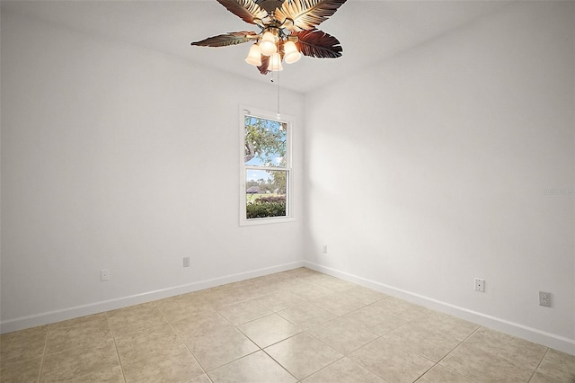 tiled empty room featuring ceiling fan