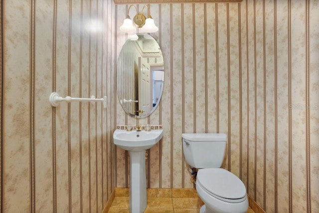 bathroom with tile patterned flooring, toilet, and sink