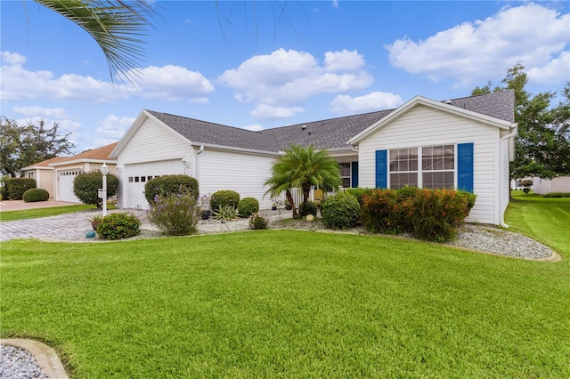 ranch-style home with a garage and a front lawn