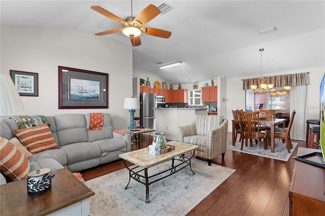 living room with vaulted ceiling, dark hardwood / wood-style floors, and ceiling fan with notable chandelier