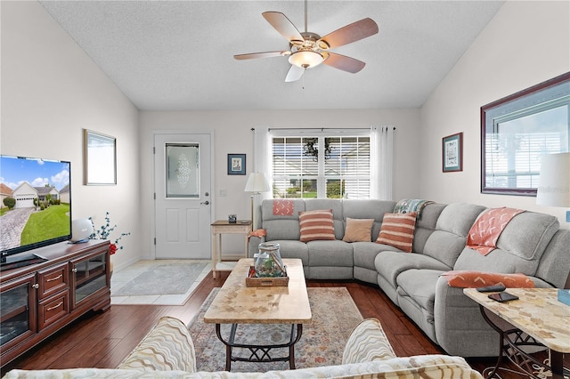 living room with lofted ceiling, ceiling fan, a textured ceiling, and hardwood / wood-style floors