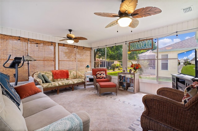 sunroom with ceiling fan, plenty of natural light, and visible vents