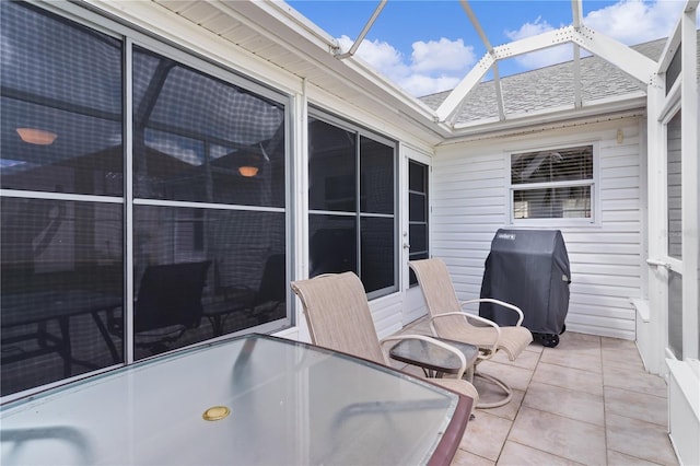 view of patio with glass enclosure and grilling area