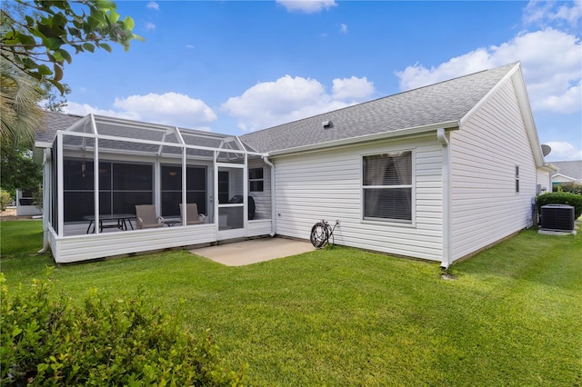 back of house featuring a yard, glass enclosure, a patio, and central AC