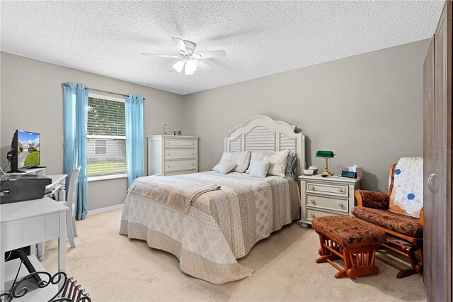 17913 SE 88th Cascade Ct, The Villages, FL 32162 - bedroom featuring baseboards, a textured ceiling, ceiling fan, and light colored carpet