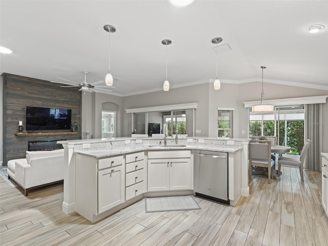 kitchen with a sink, open floor plan, vaulted ceiling, stainless steel dishwasher, and light stone countertops