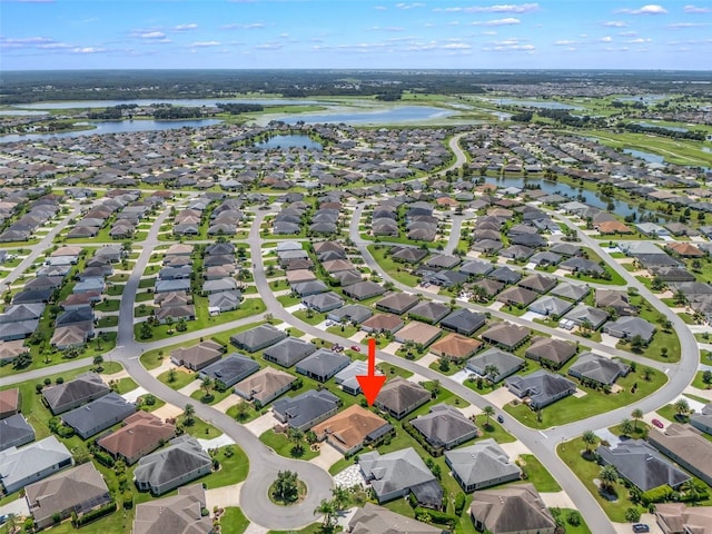 birds eye view of property with a water view and a residential view