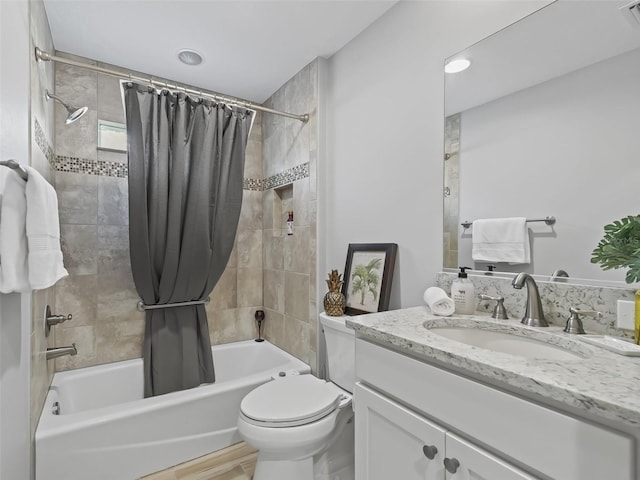 bathroom featuring visible vents, vanity, toilet, and shower / tub combo with curtain