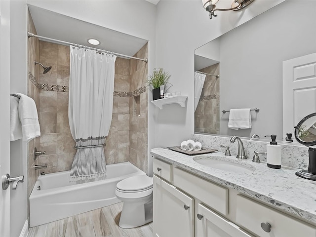 bathroom with shower / bath combination with curtain, toilet, and vanity
