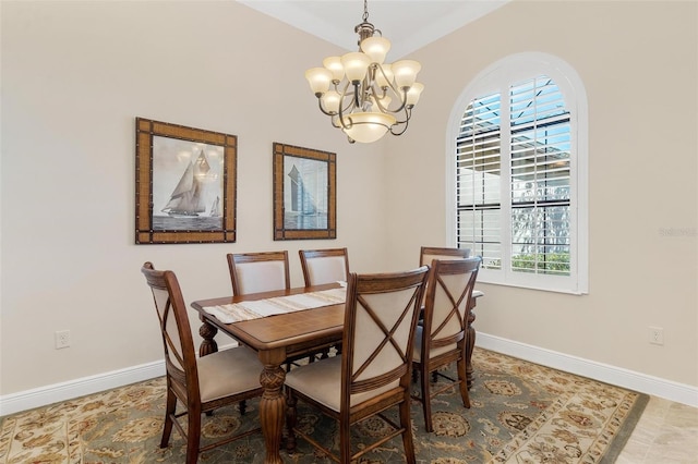 dining space with a notable chandelier and baseboards