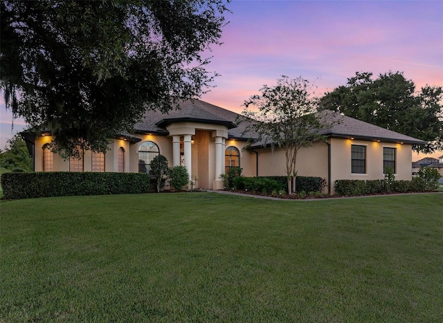 view of front facade featuring a front yard and stucco siding